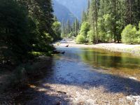 A scenic view of the Merced River flowing through Yosemite Valley